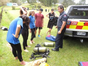 Fireman teaching students how to use gas masks.